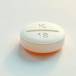 White round pill with imprint K18 for accurate identification